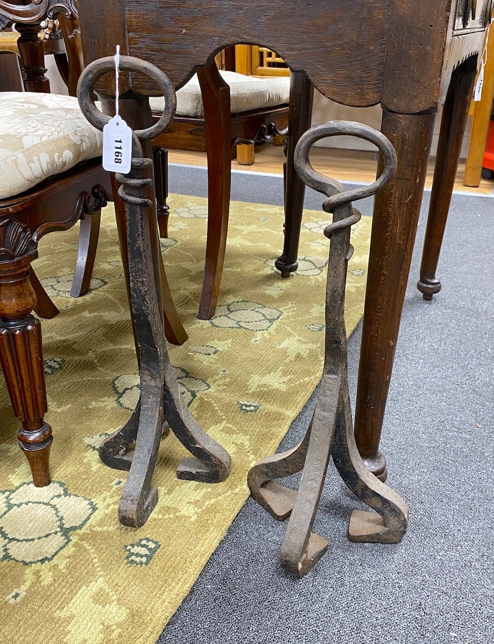 A near pair of wrought iron door stops, larger height 55cm
